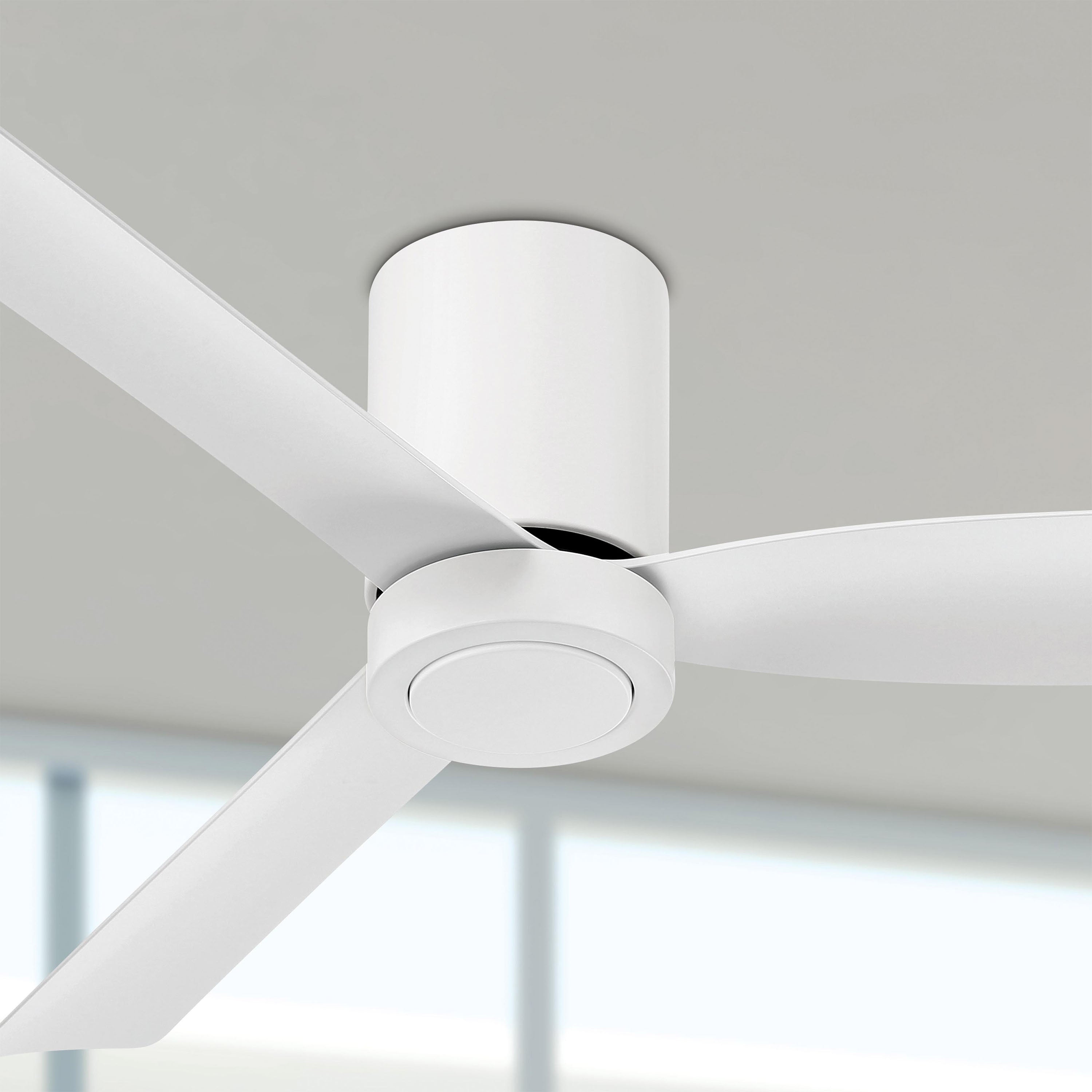 White cormac ceiling fan mounted on a ceiling with a blurred background