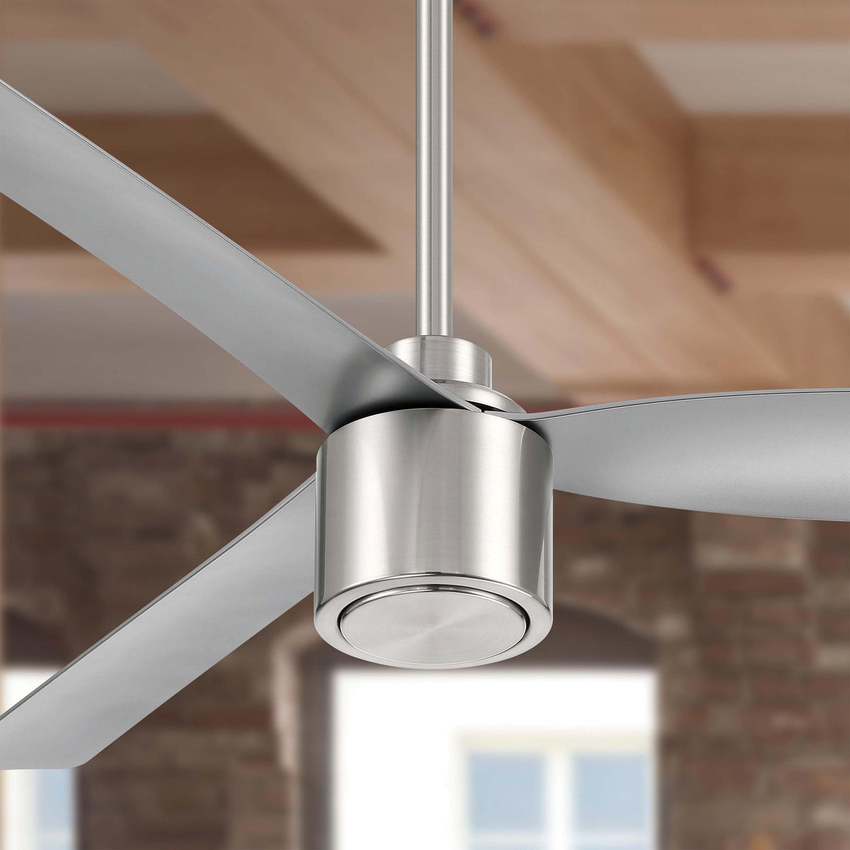 Ravian ceiling fan 3-blade in brushed nickel finish in a room with wooden beams and blurred background