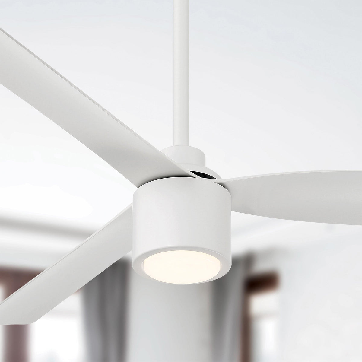 Close-up of Ravian 3-blade modern ceiling fan with light fixture in a room setting featuring matte white finish