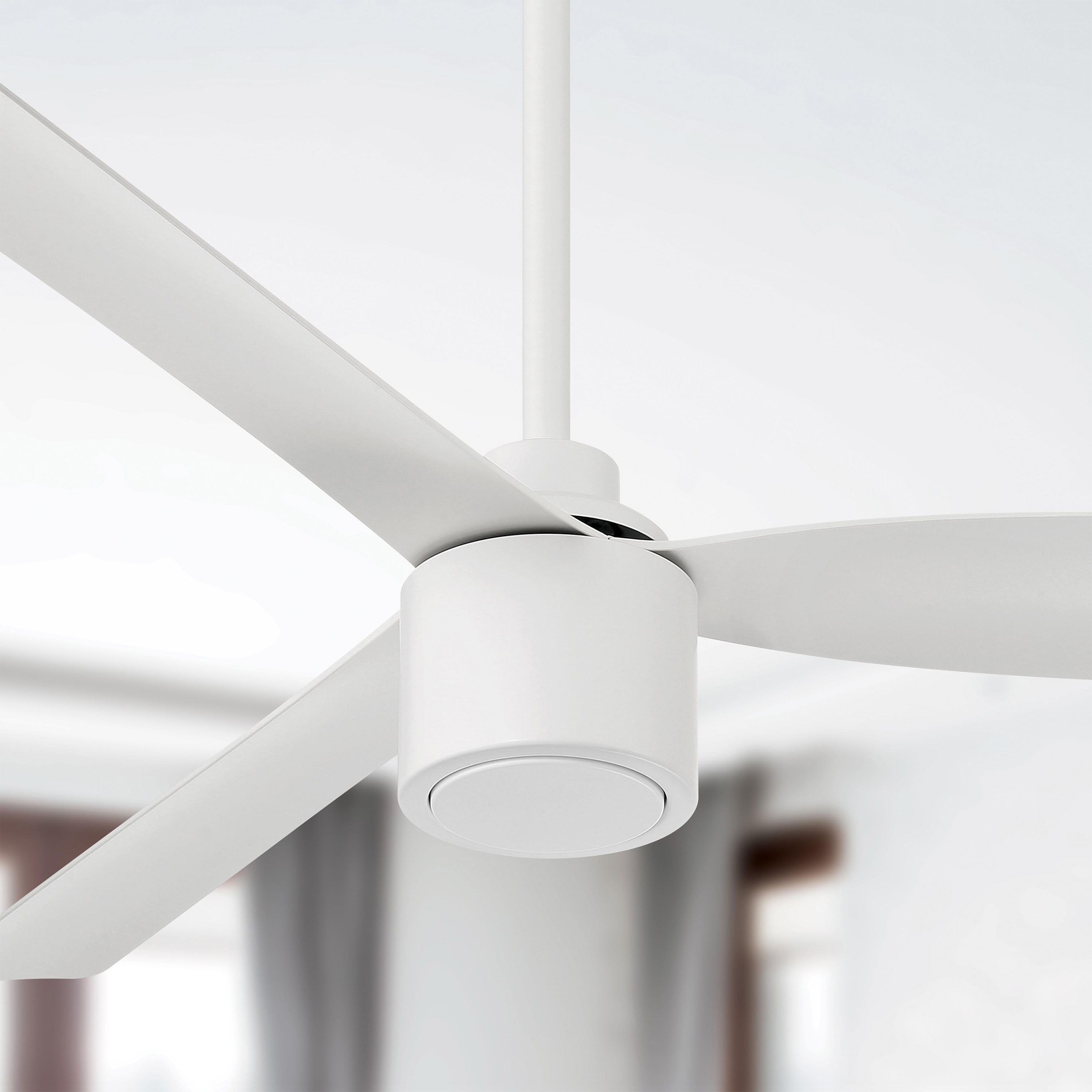 Close-up of a Ravian 3-blade matte white ceiling fan with blurred background