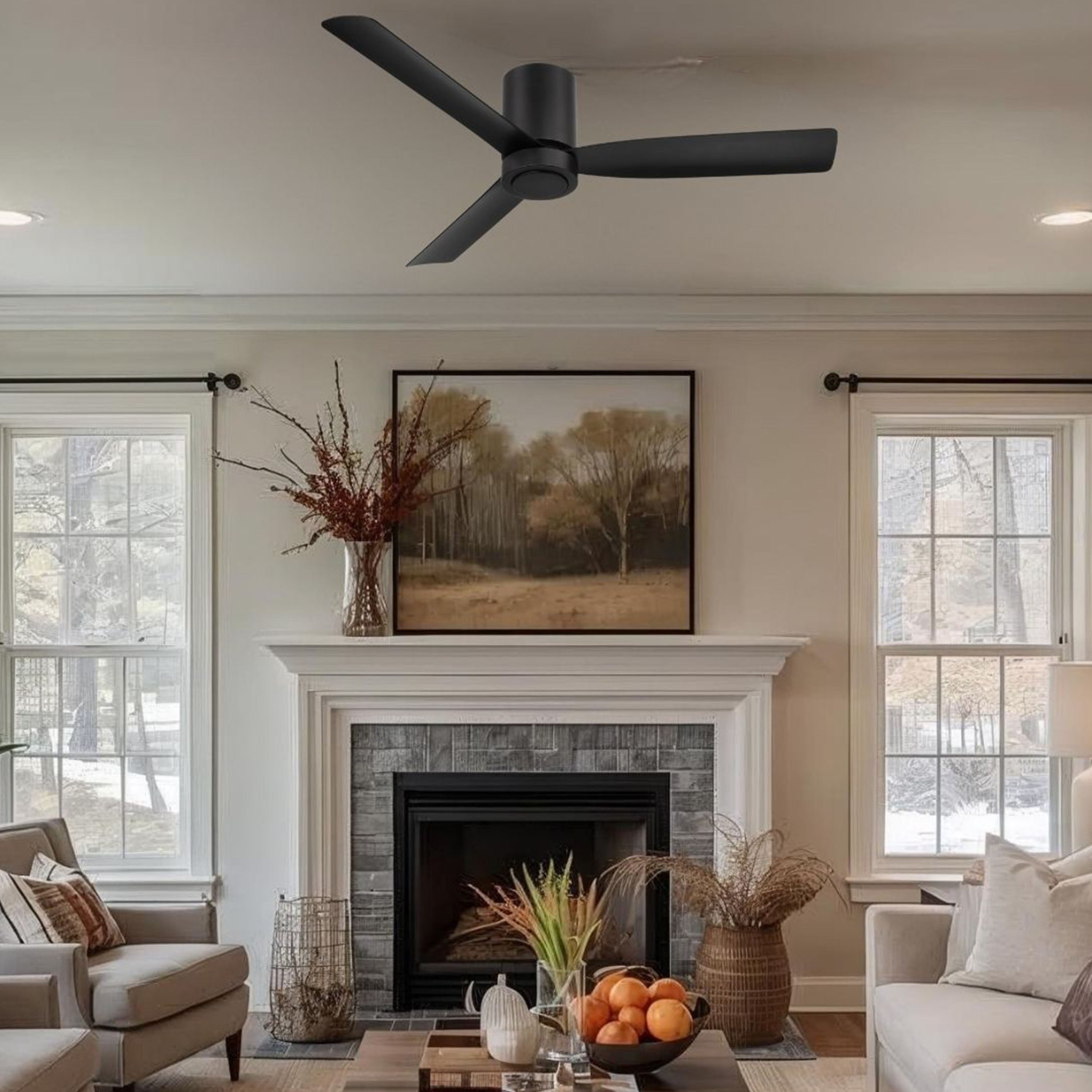 Living room featuring cormac black 3 blade ceiling fan, fireplace, and decorative elements.