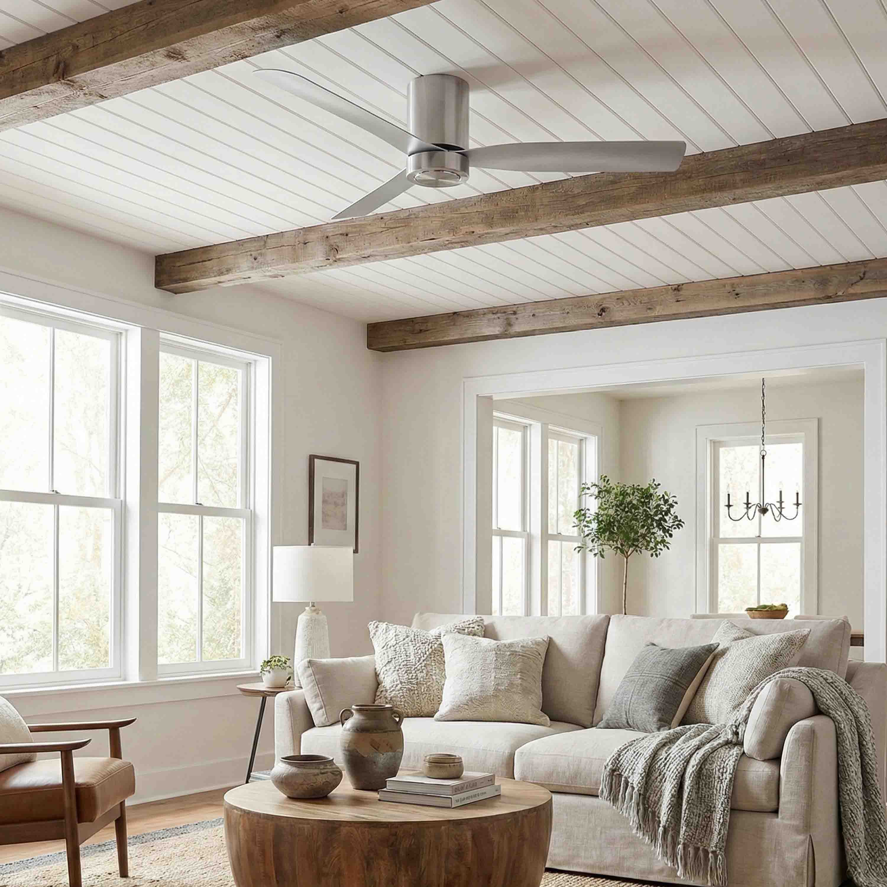 Living room featuring the Cormac ceiling fan, beige sofa, wooden coffee table, and white walls.