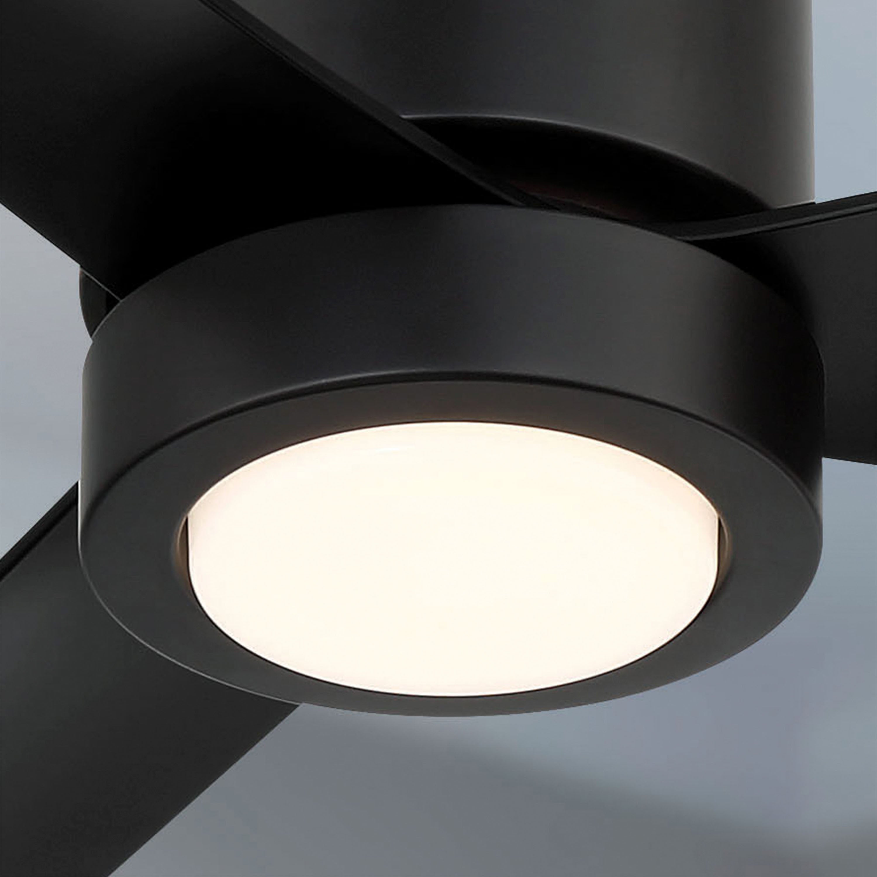 Close-up of a black cormac ceiling fan with light on a gray background