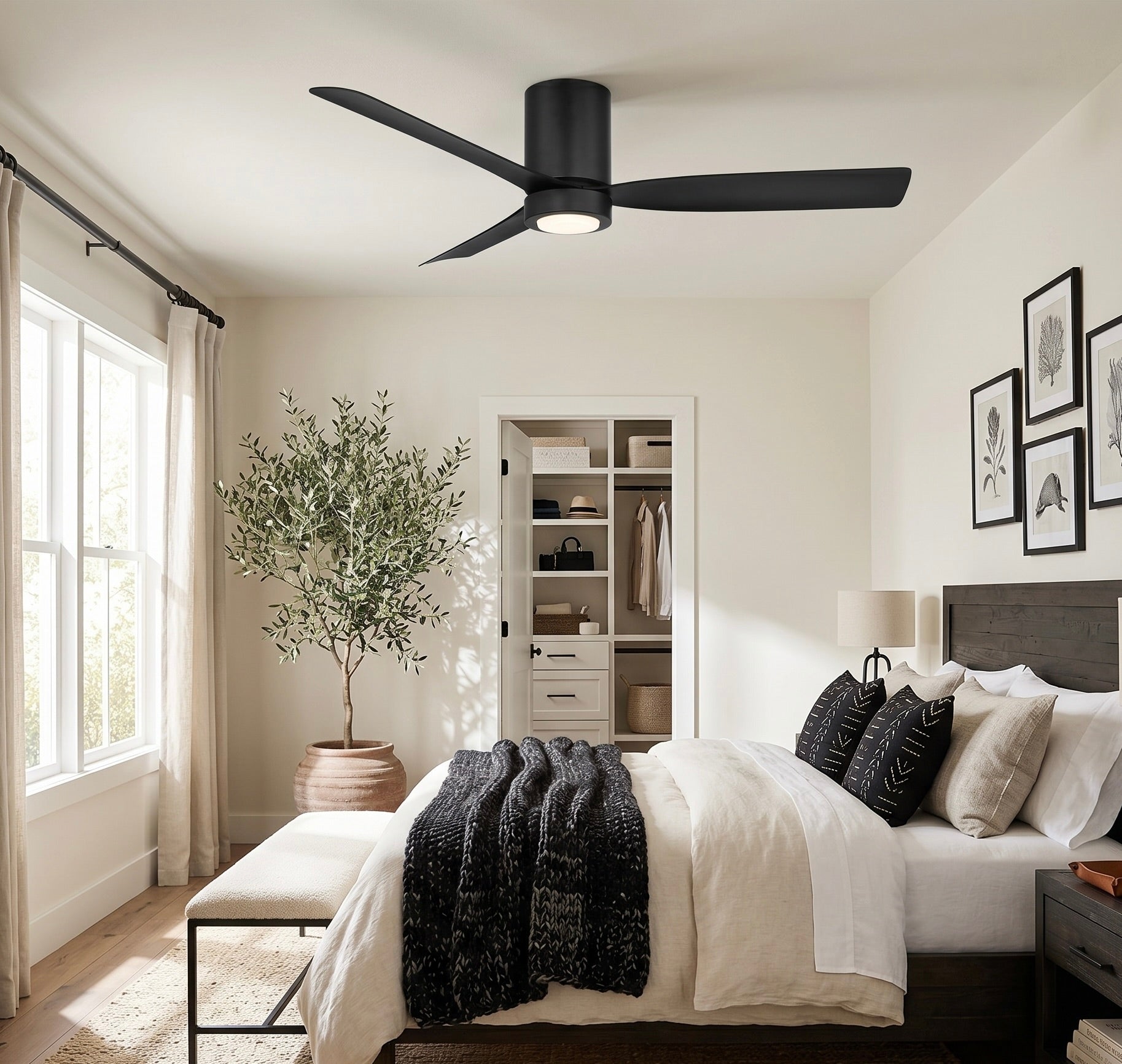 Modern bedroom with a black Cormac ceiling fan, bed, and decor elements.
