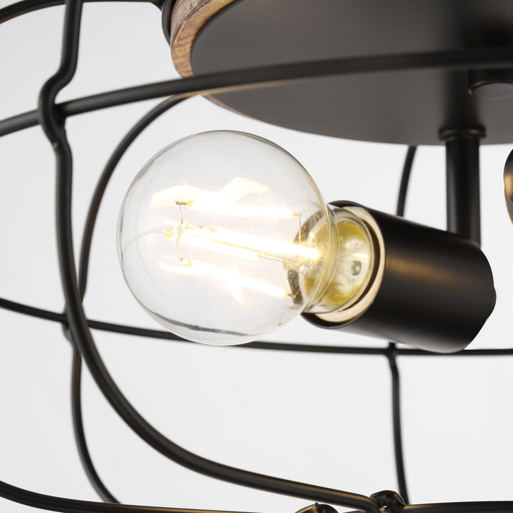 A vintage-style aged brass pendant light with a clear glass shade and a black cord for hanging.