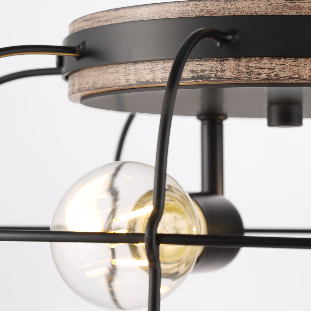 A vintage-style aged brass pendant light with a clear glass shade and a black cord for hanging.